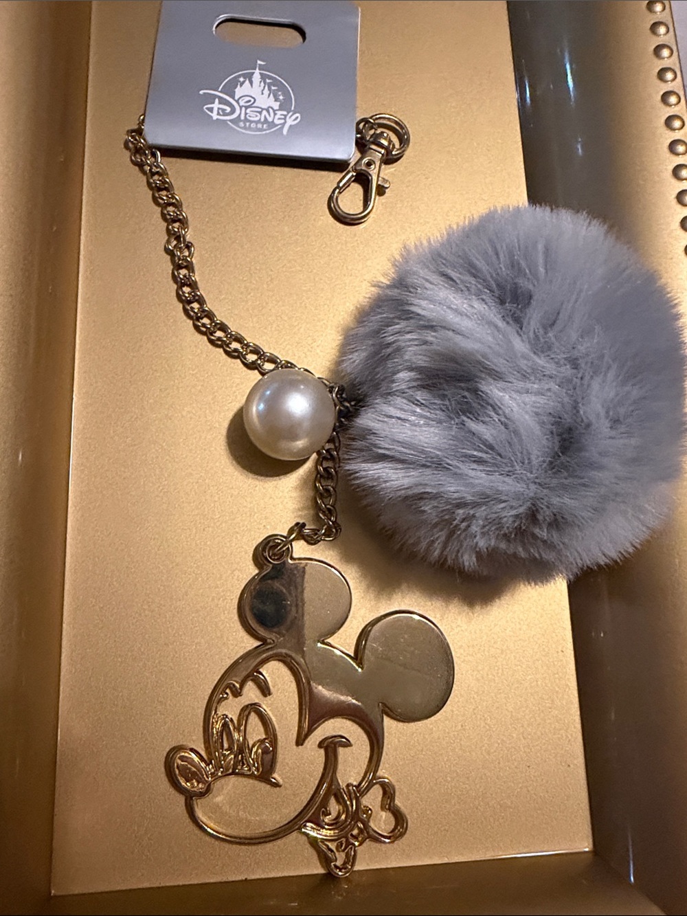 Disney Gold Mickey Outline Keychain with Gray Pom Pom